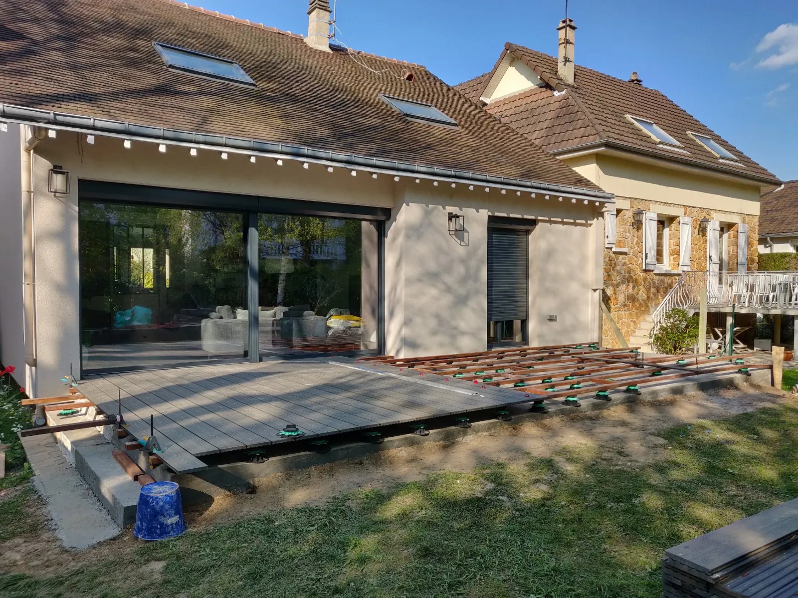 Maison avec baie vitrée coulissante et terrasse en cours de pose