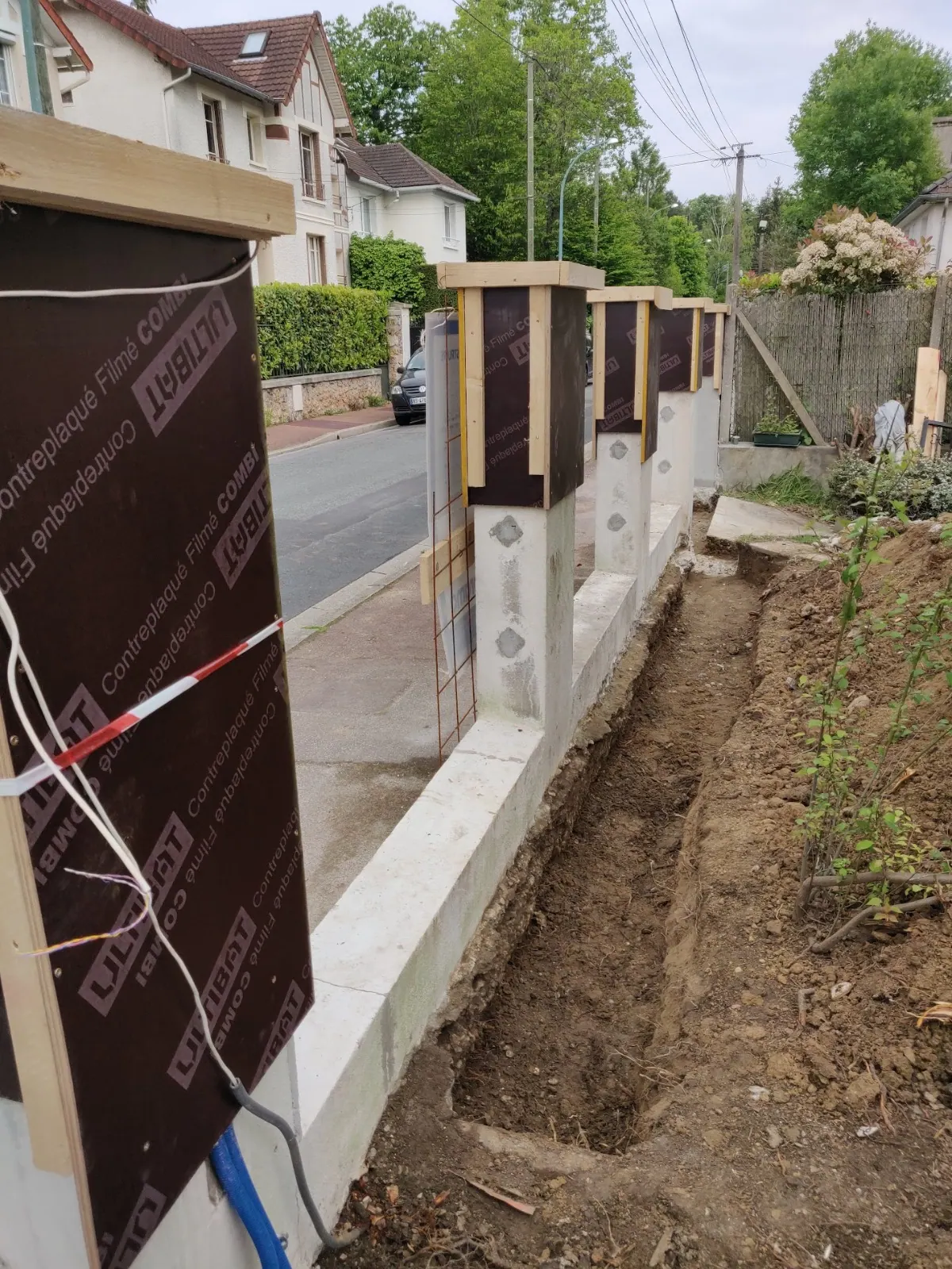 Poteaux de clôture coffrés et tranchée de fondation